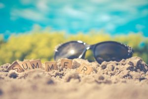 macro photography of black sunglasses on sand 1209610